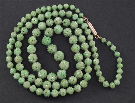 A Chinese carved jadeite bead necklace, early 20th century, total length 72.5cm, largest bead 9mm